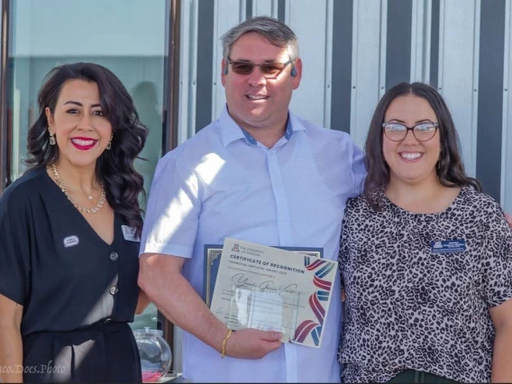 three individuals receiving award