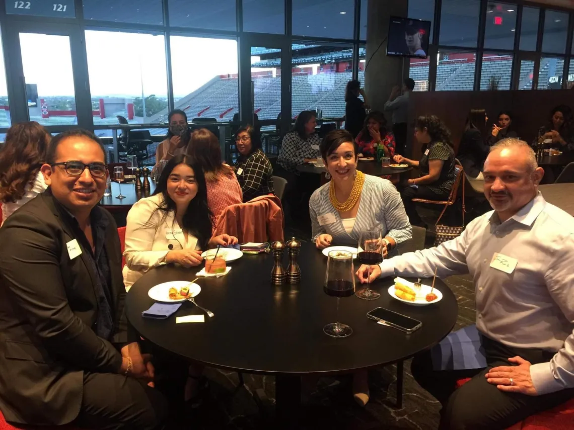 Group of 4 people sitting at a round table