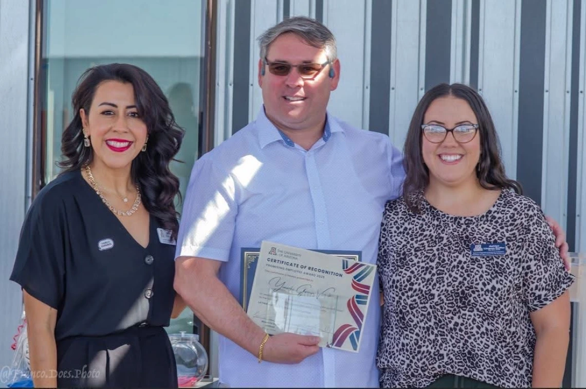three individuals receiving award