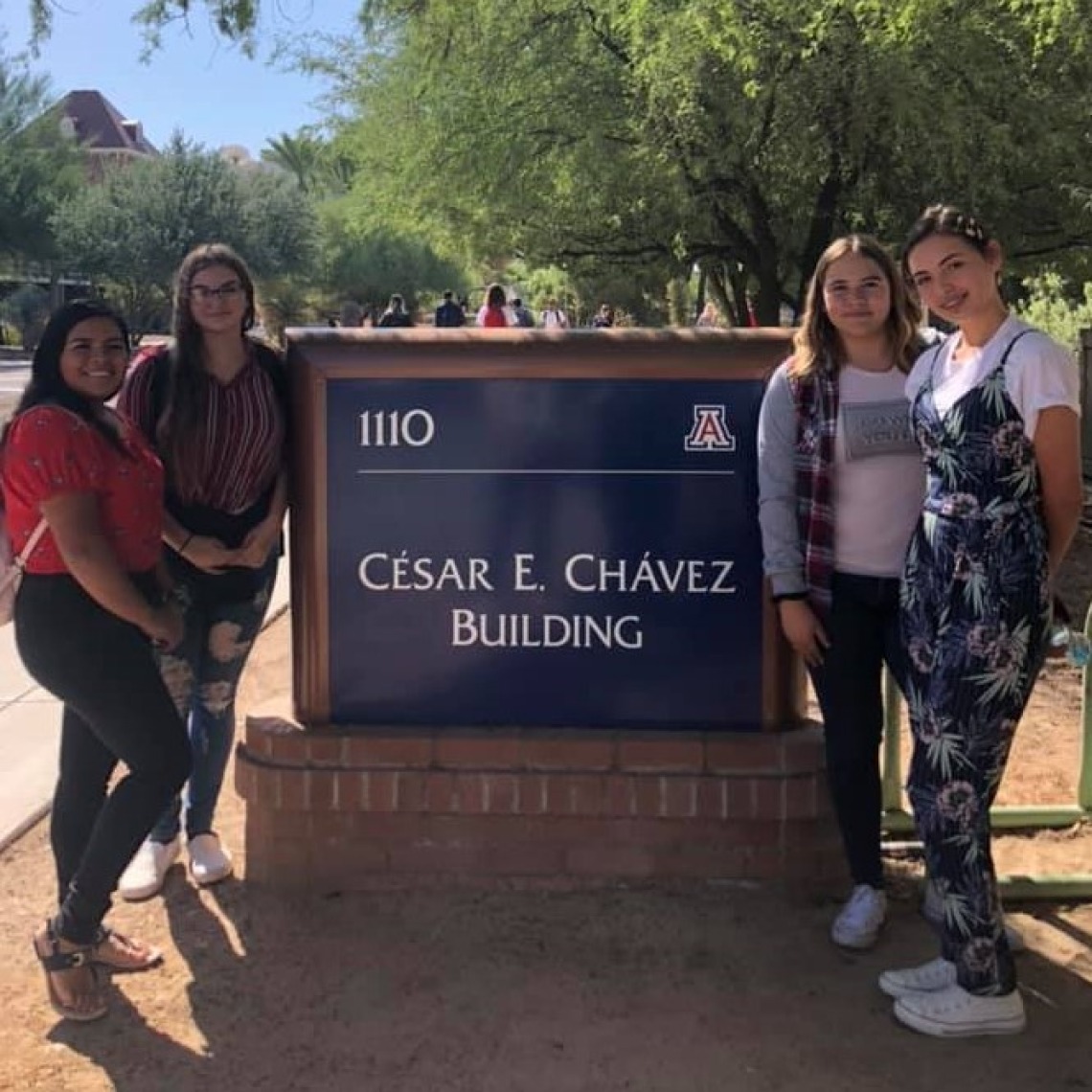 Ajo HS Students visiting UA and posing in front of the Cesar Chavez Sign  