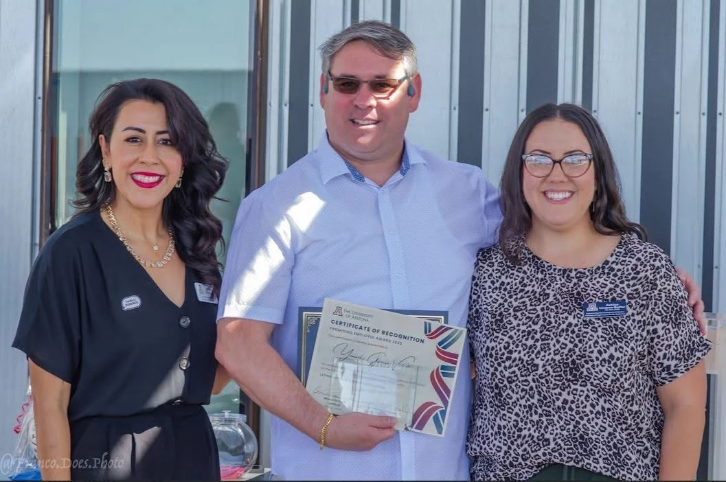 three individuals receiving award